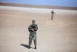 Soldiers stand guard at Krechba gas treatment plant, about