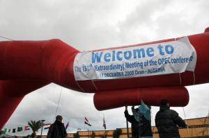 Algerian workers prepare a welcoming inflatable banner at a