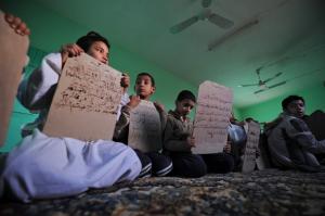 Algerian students learn Qoran during a course for learning