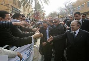 Algeria's President Abdelaziz Bouteflika shakes hands with people during