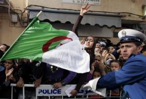 Supporters of Algeria's President Abdelaziz Bouteflika gesture during his