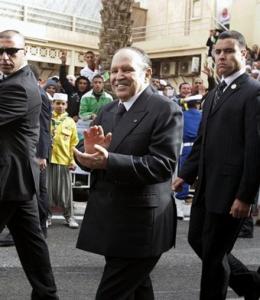 Algeria's President Abdelaziz Bouteflika, surrounded by body guards, applauds