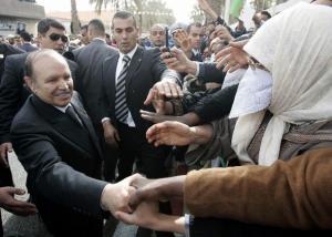 Algeria's President Abdelaziz Bouteflika shakes hands with supporters during