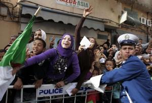 Supporters of Algeria's President Abdelaziz Bouteflika gesture during his