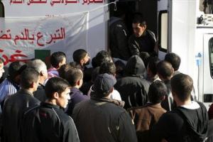 Men queue outside a mobile clinic to donate blood