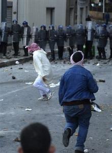 Protesters clash with riot police officers Friday, Jan. 9,
