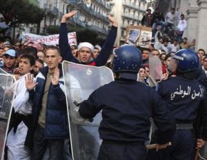 Protesters face riot police officers Friday, Jan. 9, 2009