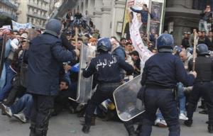 Protesters clash with riot police officers Friday, Jan. 9,