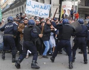 Protesters face riot police officers Friday, Jan. 9, 2009