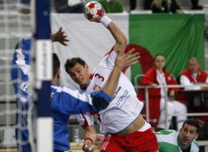 Krzysztof Lijewski (C) of Poland shoots to score front