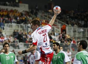Rafal Glinski (C) of Poland shoots to score front