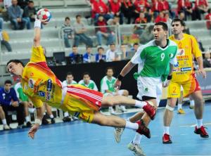 Macedonia's Vladimir Temelkov (L) shots against Algeria next to