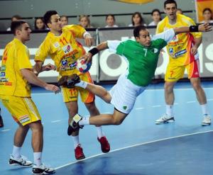 Algeria's Hichem Boudrali (R) shoots between Velko Markoski (L)