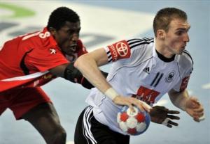 Germany's Holger Glandorf tries to escape Tunisia's Slim Hedoui