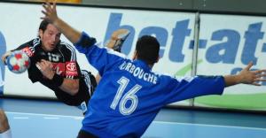 Germany's Torsten Janssen (L) shoots against Algeria's goalkeeper Samir