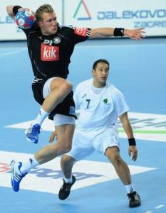 Germany's Lars Kaufmann (L) shots against Algeria's next to