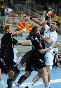 Algeria's Omar Chebour (R) shoots between Germany's Oliver Roggisch