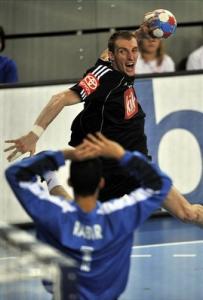 Germany's Holger Glandorf, back, tries to score against Algeria's