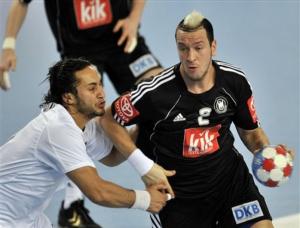 Algeria's Hamza Toum, left, and Germany's Pascal Hens challenge