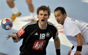 Algeria's Hichem Boudrali, right, looks after Germany's Michael Kraus