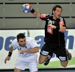 Germany's Torsten Jansen, right, throws in front of Algeria's