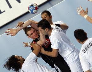 Germany's Lars Kaufmann (C) fights for a ball with