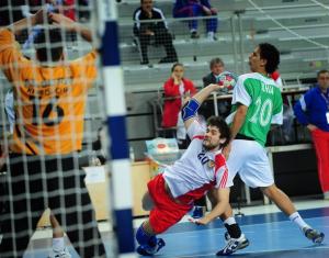 Russia's Mikhail Chipurin (C) vies for the ball with