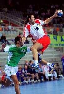 Russia's Roman Ivanov (R) vies for the ball with