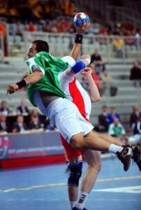 Algeria's Hichem Boudrali (L) shoots against Russia during