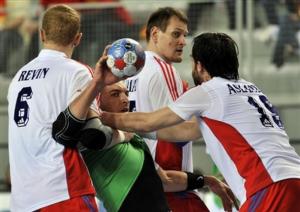 Algeria's Aziz Benkahla, center, is blocked by Russia's Mikhail