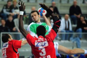 Algeria's Hamza Zouaui  (C) shoots above  Tunisia's