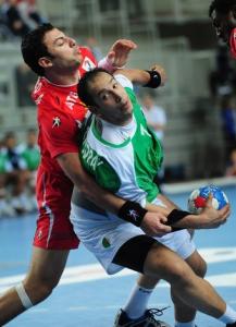 Algeria's Hichem Boudrali (C) vies for the ball with