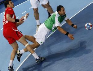 Tunisia's Jaleleddine Tuati attempts to score next Algeria's Yacinn