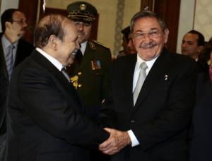 Algeria's President Abdelaziz Bouteflika (L) shakes hands with his