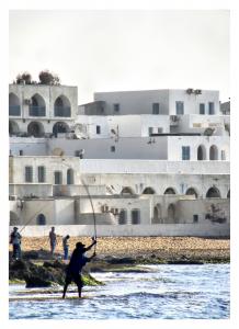 Smart fisherman with coastal architecture
