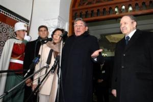 Cuban President Raul Castro, center, speaks to reporters as