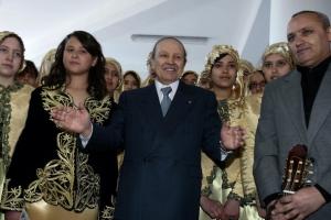 Algeria's President Abdelaziz Bouteflika poses with musicians at a