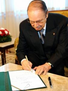 Algerian President Abdelaziz Bouteflika signs his official Presidential candidature