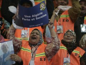 Supporters of Algeria's President Abdelaziz Bouteflika gesture during an