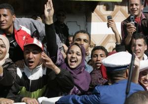 Supporters of Algeria's President Abdelaziz Bouteflika gesture during an