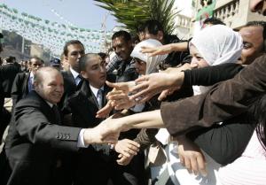 Algeria's President Abdelaziz Bouteflika shakes hands with supporters during