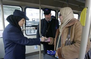 Ghazali Ghania, 33, collects a ticket for the first
