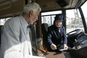 Denni Fatiha, 48, helps a passenger in Algiers