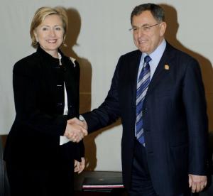 U.S. Secretary of State Hillary Clinton (L) shakes hands