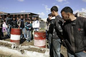 People gather at the site of a suicide bomb