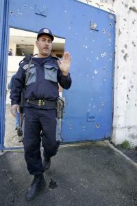 A guard gestures in front of the gate of
