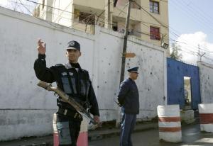 A guard stands by the gate of a government