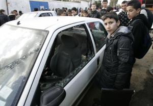A schoolboy looks at the damage caused by a