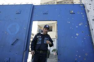 A guard stands by the gate of a government