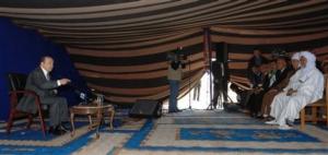 Algerian President Abdelaziz Bouteflika, right, meets residents as he campaigns